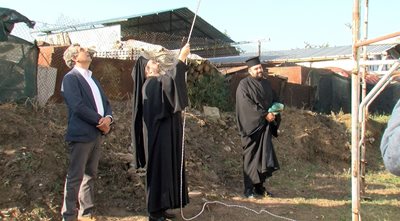 Rosen Plevneliev watches as the priests ring the bell he donated to the church in the village of Balgarchevo.