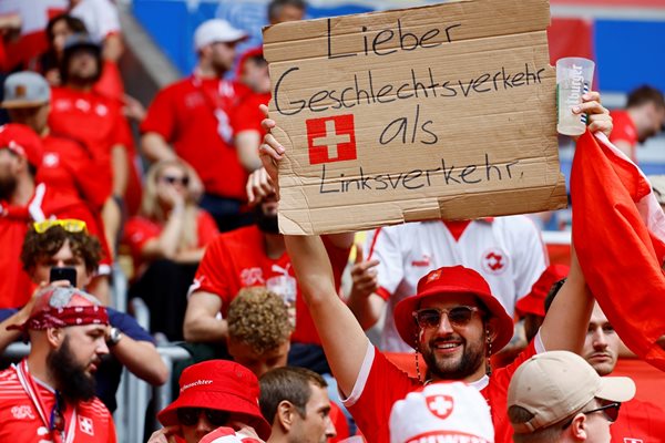 A Swiss fan announces that it's better to have sex than to drive on the left side of the road.