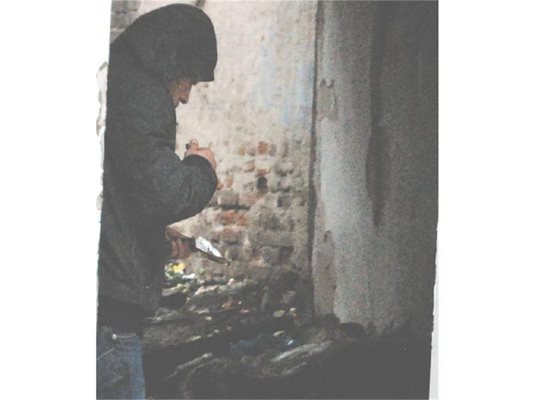 Дилър наркоман пуши хероин на входа на "постата" на ул. "Пиротска". 
СНИМКИ: ХРИСТО РАХНЕВ
