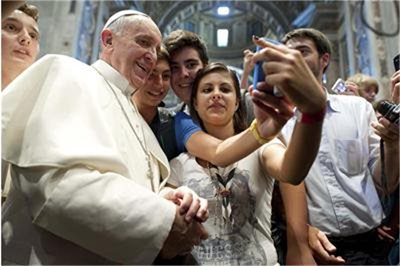 Младежи се снимат със смартфон в базиликата “Свети Петър” във Ватикана. Папа Франциск също се включи в селфито.