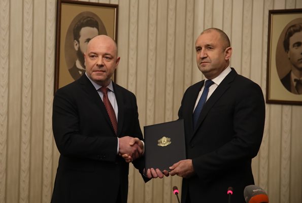 Румен Радев и номинираният за премиер Николай Габровски си разменят папката с мандата.