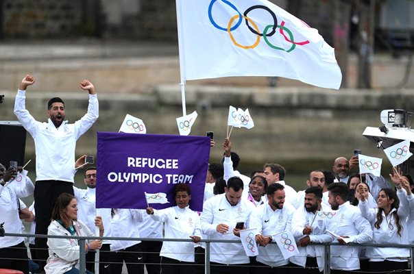 Athletes from the refugee Olympic team on a boat during the parade along the Seine River during the opening ceremony Photo: Reuters