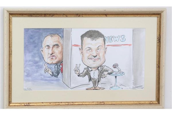 Карикатурата с Бойко Борисов и Бареков виси на стената зад бившия тв водещ в офиса му.
СНИМКИ: АНДРЕЙ БЕЛОКОНСКИ
