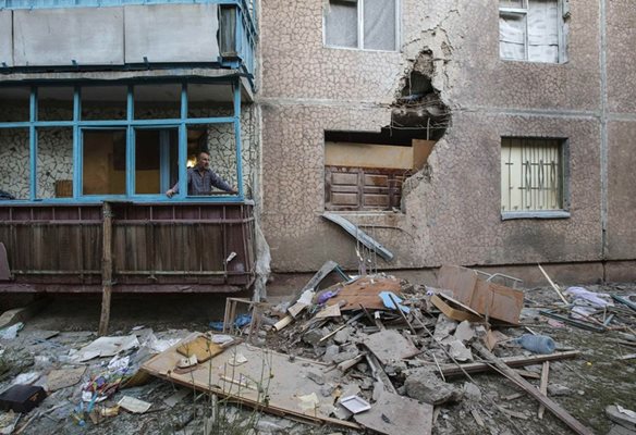 Жители на Славянск оглеждат пораженията по блока си.
