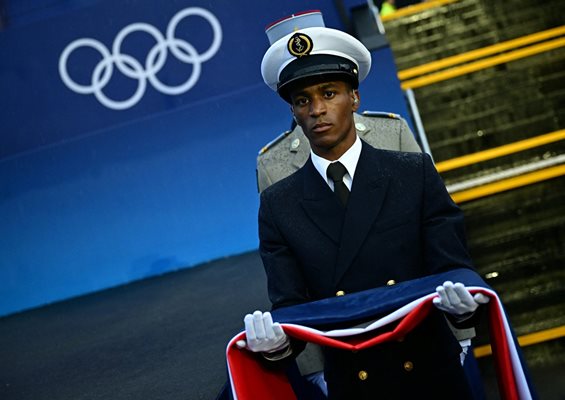 France's armed forces carry the French flag during the ceremony Photo: Reuters