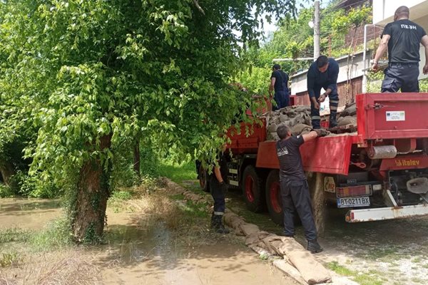 Пожарникари градят дига с чували пясък