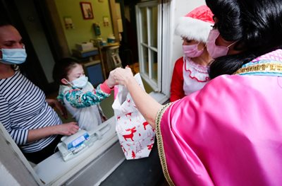 Volunteers give gifts to children in Germany.  PHOTO: Reuters