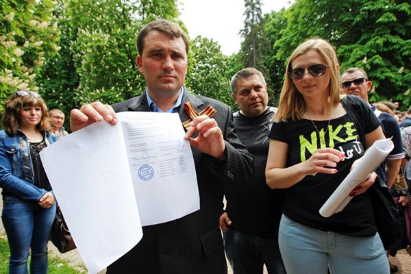 Шефът на изборната комисия в Луганск показва резултатите от референдума.